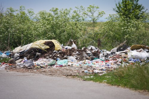 Company van and crew preparing for commercial waste collection in urban area